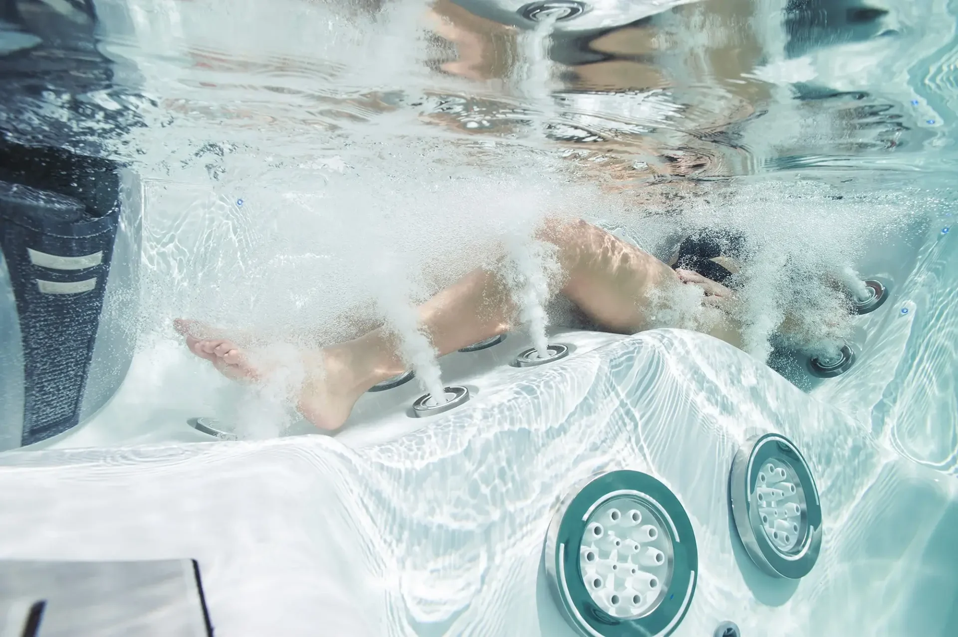 master spas Twilight 8.2 Lifestyle Underwater Woman sitting in lounge Master Blaster